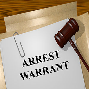 Warrants: A legal document labeled "ARREST WARRANT" with a paperclip and a wooden gavel resting on top of it.