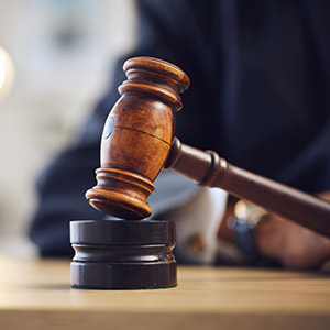 Judge's wooden gavel resting on its base, symbolizing a bench warrant for failing to appear in court.