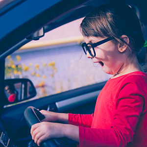 Woman looking distressed while sitting in a car: legal defense for domestic violence.