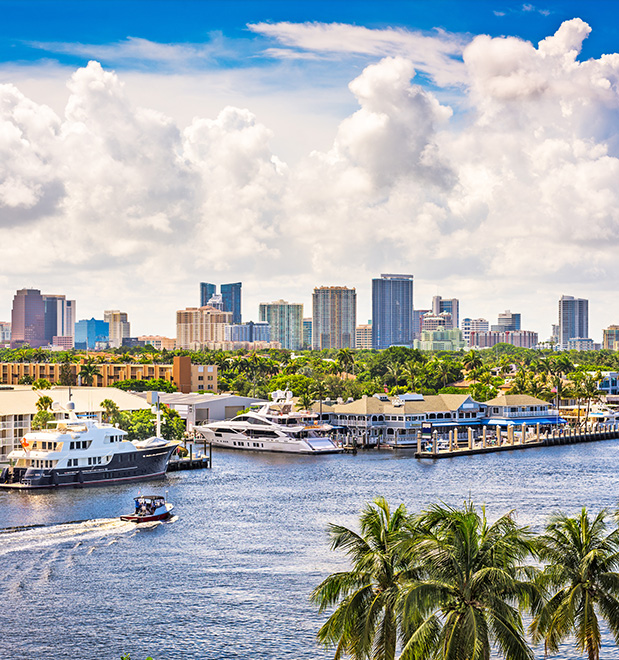 Fort Lauderdale skyline and waterfront with luxury yachts, palm trees, and a testimonial icon.  